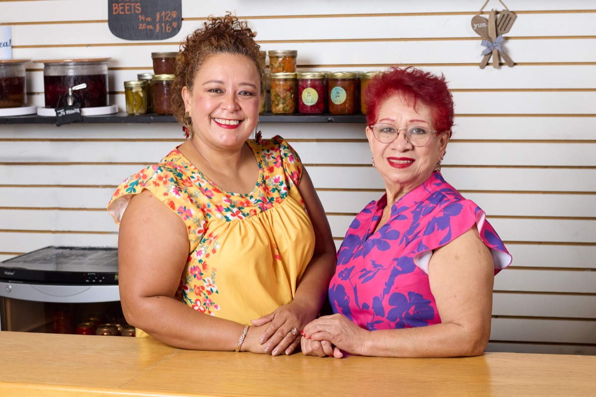 Wendy and her mother behind the counter at their market stand